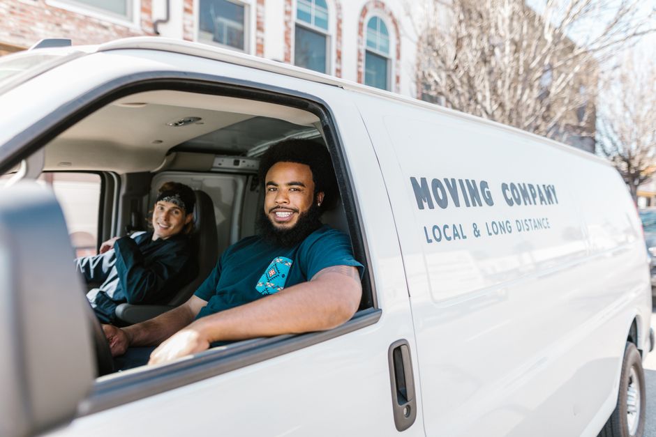 Friendly moving professionals smiling and ready to assist